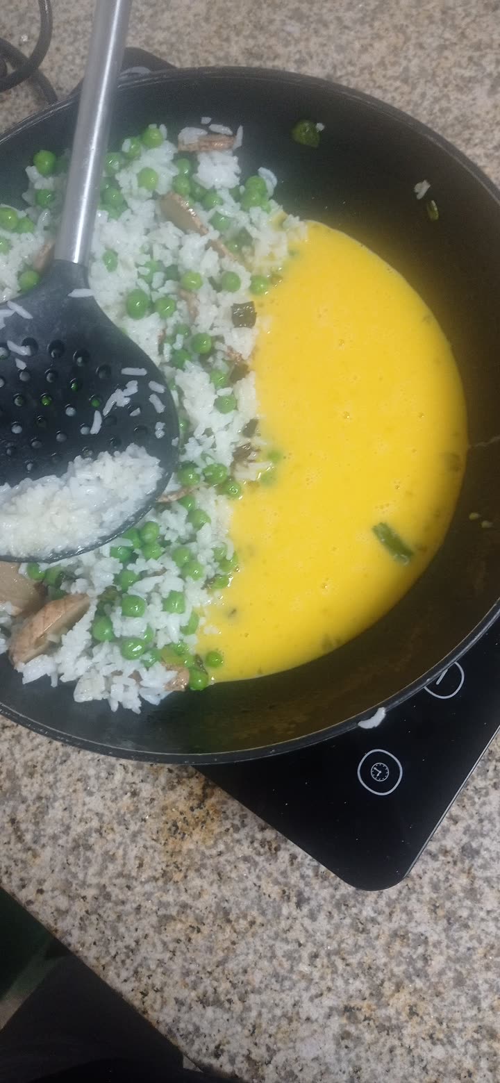 beaten egg poured into the cleared side of the wok