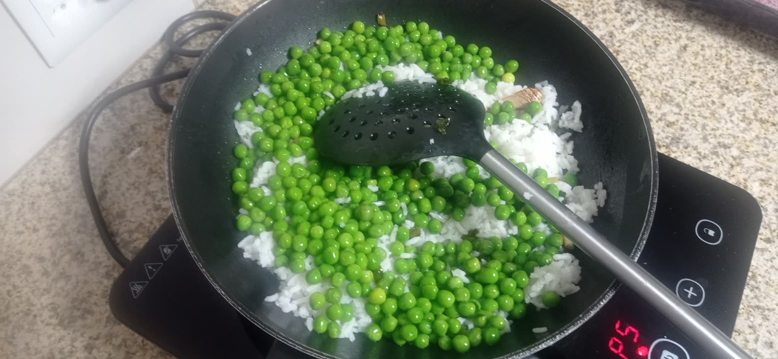 rice and peas added to the wok