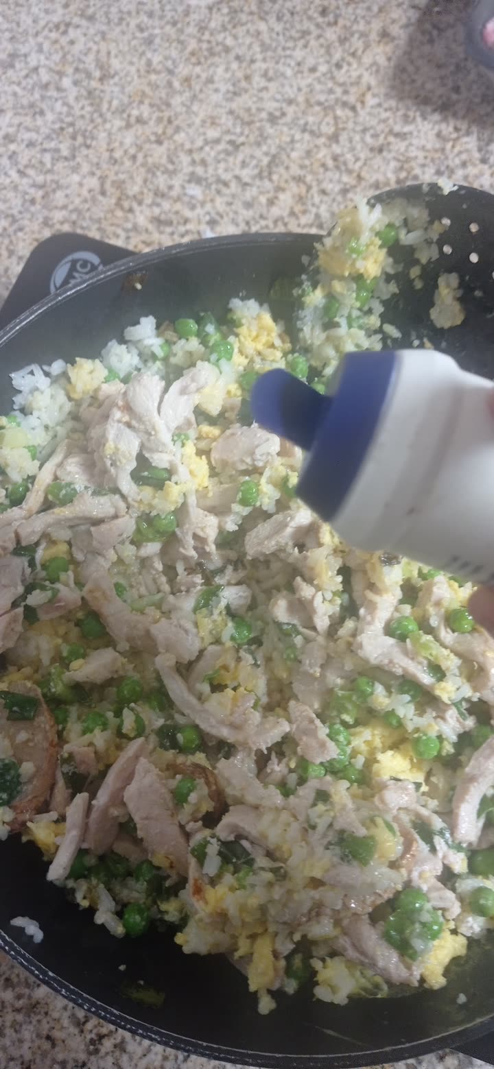 sesame oil squeezed over the combined fried rice