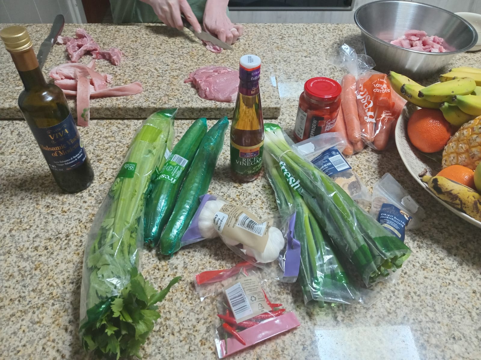 the Checkers order laid out on the counter, pork being sliced behind it