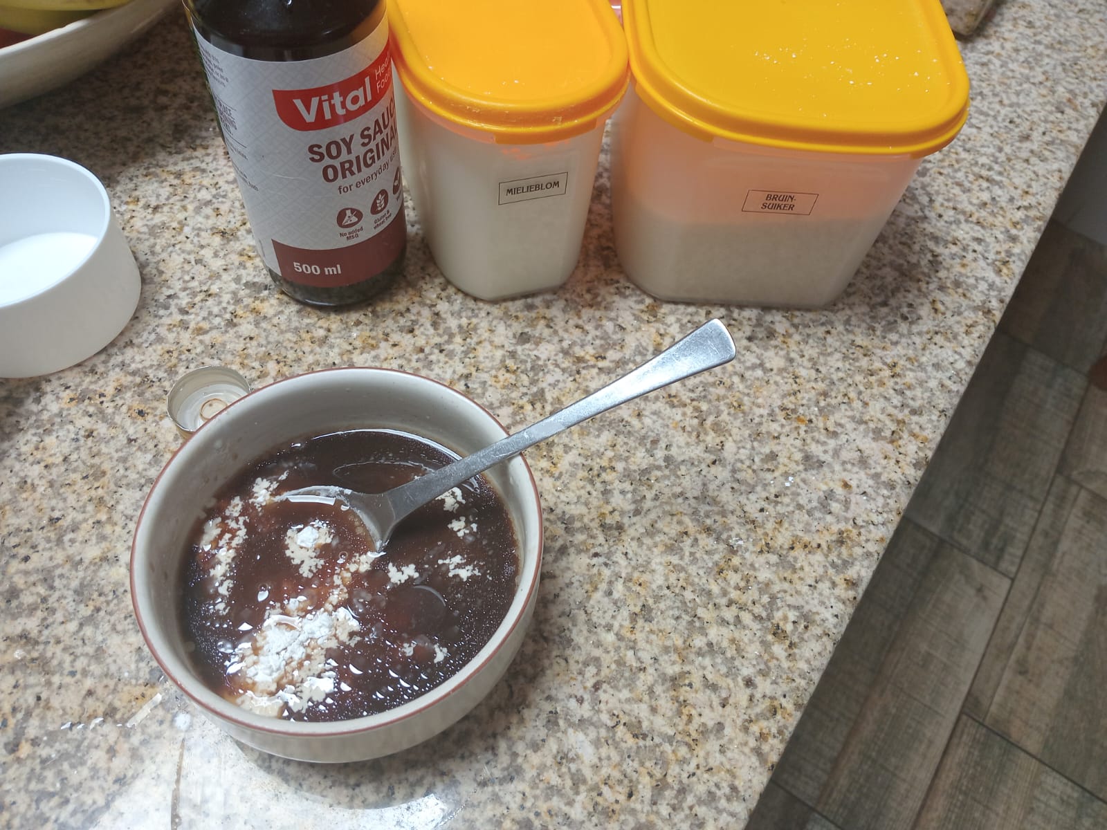 soy sauce and the Mielieblom and Bruinsuiker tubs behind a bowl, the Maizena not yet stirred in